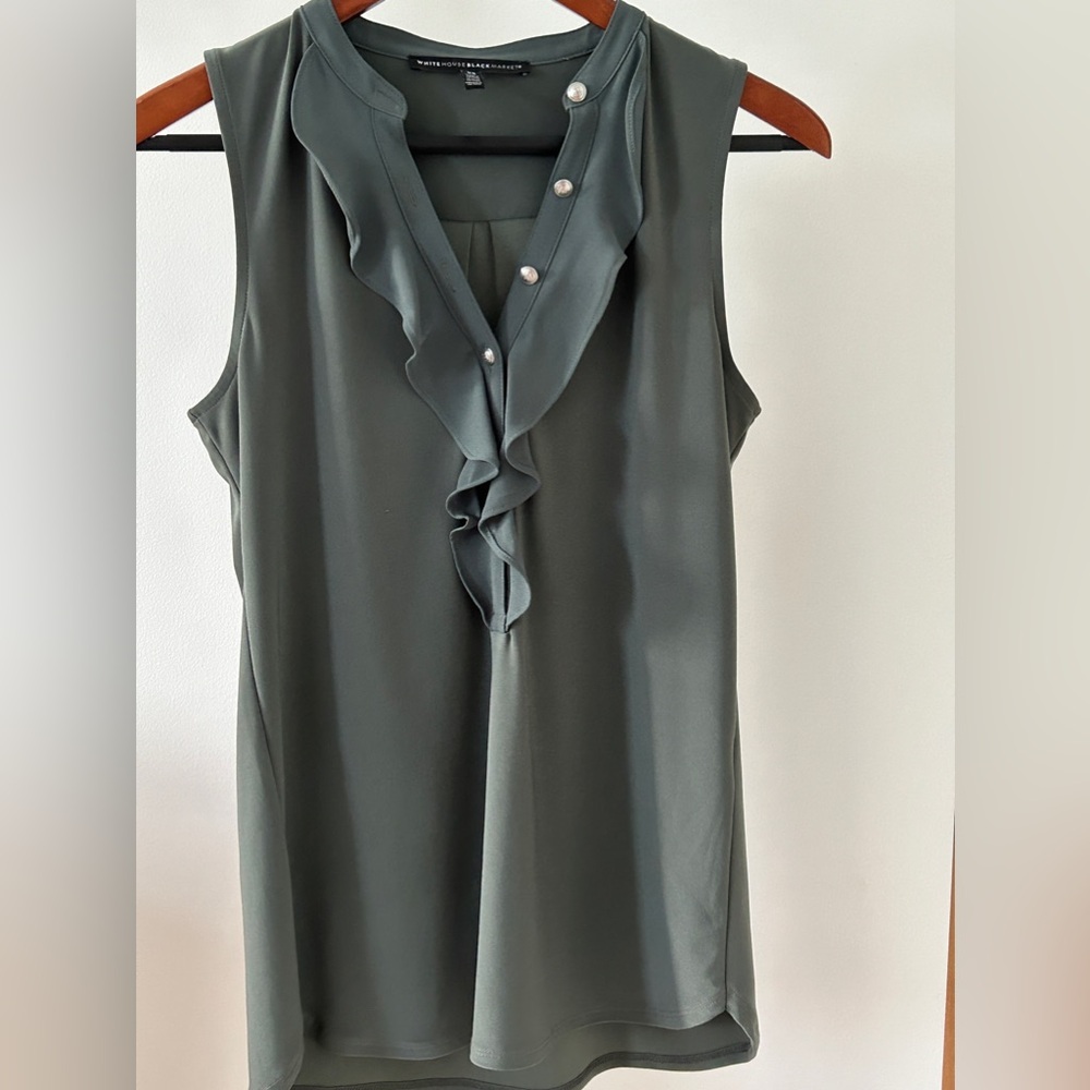Green sleeveless blouse from White House black market. Ruffled front.